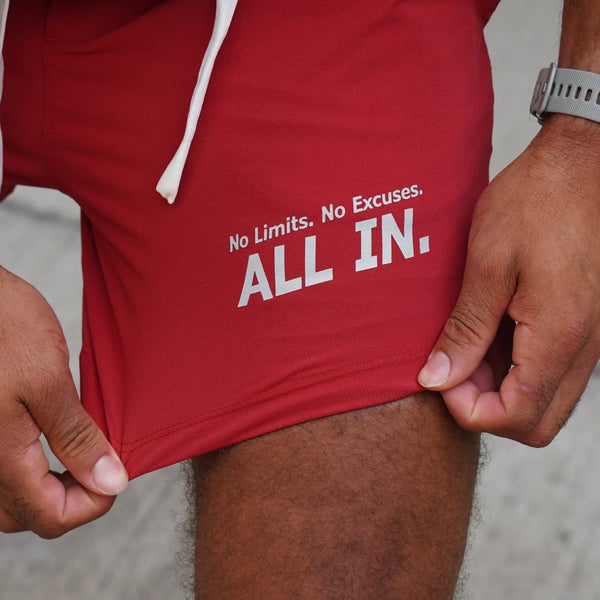Red shorts with 'No Limits. No Excuses. ALL IN.' text on a neutral background