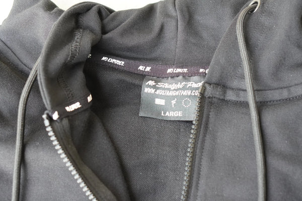 Close-up of a gray hoodie with a No Straight Path® brand label on a white background