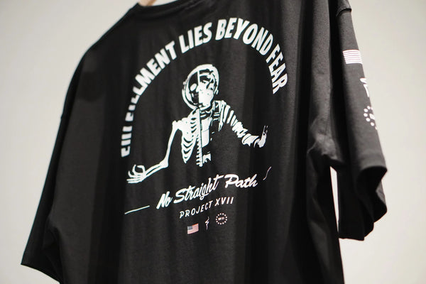 Black t-shirt with white skeleton graphic design and text on a plain background