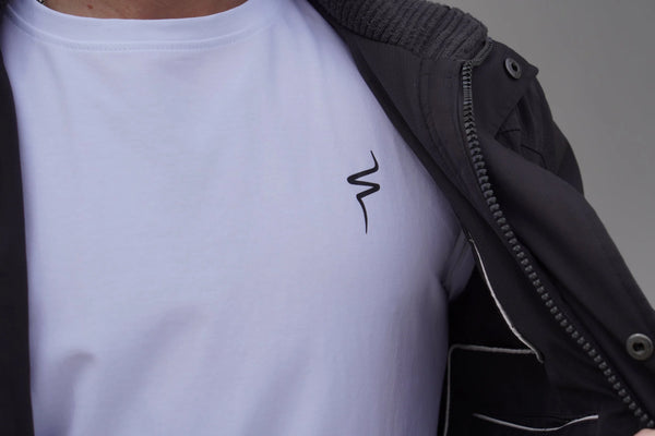 Person wearing a white t-shirt with a black No Straight Path® logo on a gray background