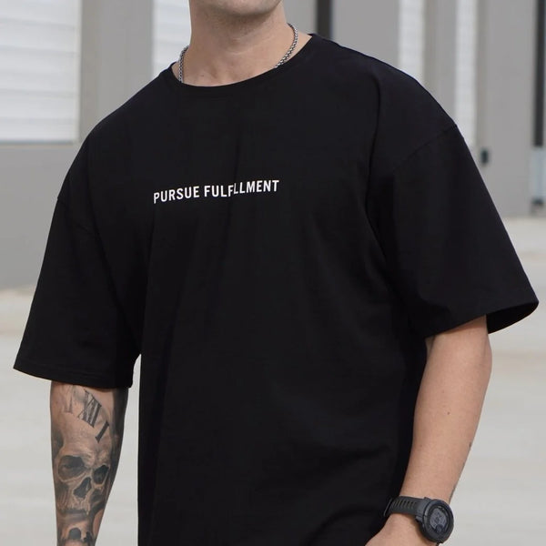 Person wearing a black t-shirt with 'Pursue Fulfillment' text.