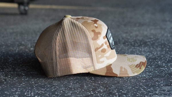 Camouflage baseball cap on a dark textured surface
