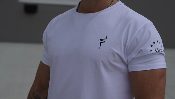 Person wearing a white t-shirt with a No Straight Path® logo on the chest and text on the sleeve.