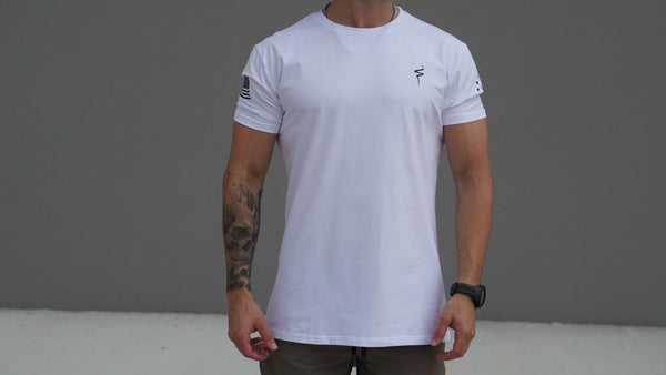 Person wearing a white t-shirt with a No Straight Path® logo on a gray background
