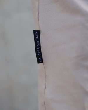 Label on a beige fabric with 'No Straight Path' text.