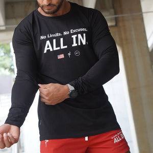 Person wearing a black long-sleeve shirt with motivational text and red shorts.
