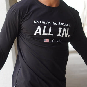 Black long-sleeve shirt with motivational text and logos on a neutral background