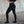 Female wearing black leggings with No Straight Path® text on a concrete floor and wall background