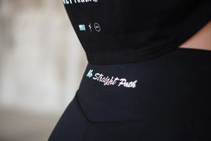 Black outfit with No Straight Path® text and logos on a blurred background