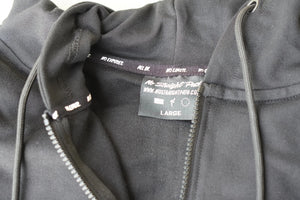 Close-up of a black hoodie with a No Straight Path® brand label on a white background