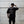 Person wearing a black t-shirt with motivational text against a concrete wall