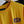 Yellow t-shirt with 'NSP' logo on a hanger
