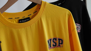Yellow t-shirt with 'NSP' logo on a hanger