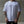 Person wearing a white t-shirt with small No Straight Path® logos against a concrete wall.