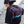 Woman wearing a black t-shirt with a colorful No Straight Path® logo, standing on stairs.