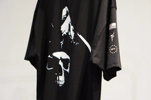 Black t-shirt with white graphic design on a plain background