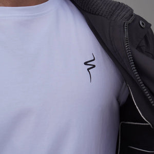 Person wearing a white t-shirt with a black No Straight Path® logo on a gray background