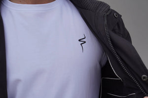 Person wearing a white t-shirt with a black No Straight Path® logo on a gray background