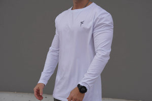 Person wearing a white long-sleeve shirt with a No Straight Path® logo on a gray background