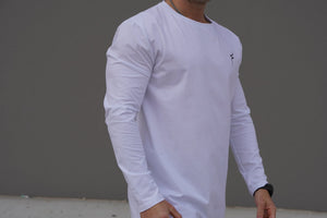 Person wearing a white long-sleeve shirt with a No Straight Path® logo on a gray background