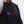 Person wearing a black t-shirt with pink No Straight Path® logos on a light gray background