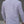 Person wearing a white long-sleeve shirt against a gray background