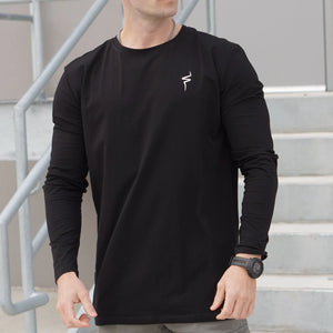 Person wearing a black long-sleeve shirt with a No Straight Path® logo on a staircase background