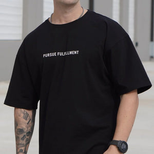 Person wearing a black t-shirt with 'Pursue Fulfillment' text.