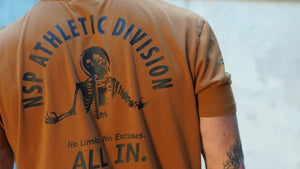 Tan t-shirt with 'Athletic Division' text and skeleton graphic on the back.
