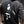Person wearing a black t-shirt with a graphic design on the back, standing against a neutral background.