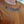Person wearing a brown shirt with No Straight Path® text in blue.