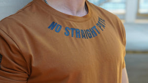 Person wearing a brown shirt with No Straight Path® text in blue.