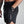 Person wearing black shorts with a No Straight Path® logo on a white background