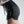Person wearing black athletic shorts with a No Straight Path® logo on a plain background