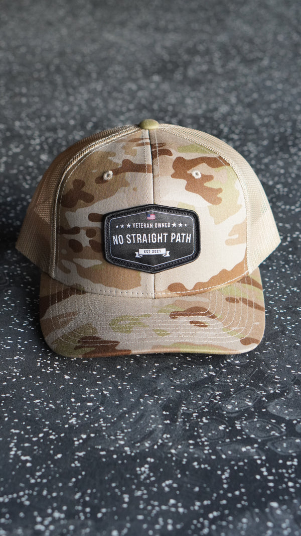 Camouflage-patterned cap on a textured surface