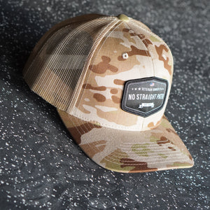 Camouflage baseball cap with a brand logo on a textured surface
