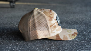 Camouflage baseball cap on a dark textured surface