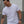 Man wearing a white t-shirt with a black No Straight Path® logo, standing outdoors.