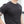 Person wearing a black t-shirt with a white No Straight Path® logo on a blurred background