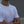 Person wearing a white t-shirt with a black No Straight Path® logo, standing against a blurred background