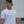 Man wearing a white t-shirt with a small No Straight Path® logo and a black cap, standing against a plain background.