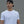 Man wearing a white t-shirt with a black No Straight Path® logo and a black cap against a gray background