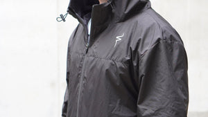 Black jacket with a No Straight Path® logo on a light gray background