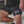 Person wearing black shorts with white text and design, standing on a concrete surface.
