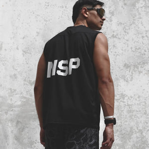 Man wearing a black sleeveless shirt with 'NSP' on the back against a textured gray wall.