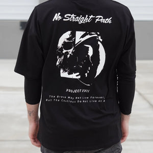 Person wearing a black t-shirt with white graphics and text on the back.