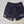 Black patterned shorts with white accents on a concrete surface