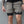 Person wearing gray shorts with 'All In.' logo against a gray background