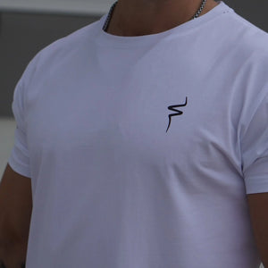 Person wearing a white t-shirt with a No Straight Path® logo on the chest and text on the sleeve.