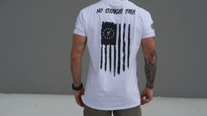 Person wearing a white t-shirt with a black graphic design on the back, standing against a gray background.